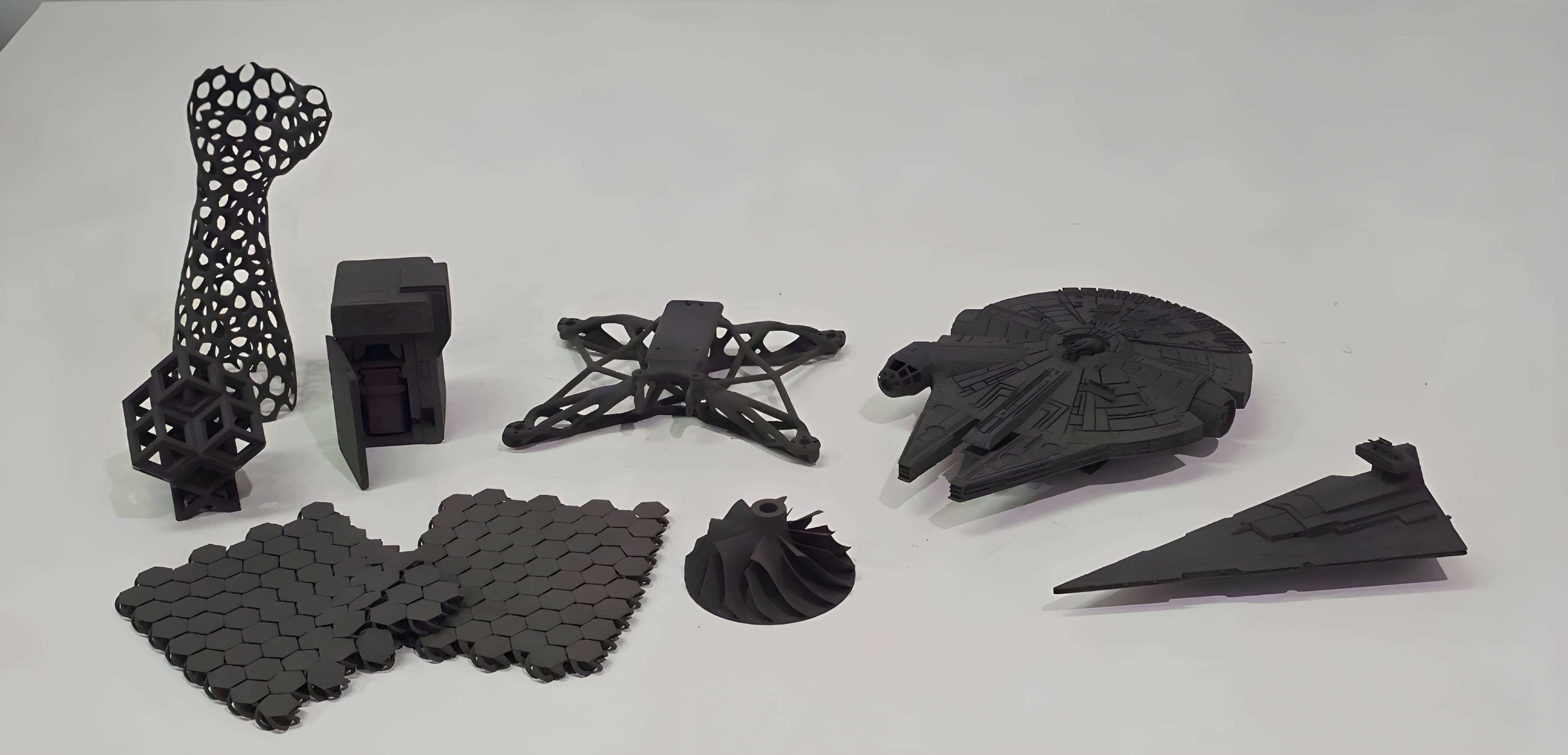 A spread of SLS 3D printed parts: lattices, brackets, an impeller and scale models